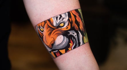 A vivid tiger tattoo on an arm at Wobee Tattoo, Cork, County Cork, IE.
