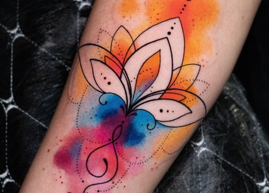 Colorful flower tattoo on arm at Wobee Tattoo, Cork, County Cork, IE, showcasing vibrant artistry.
