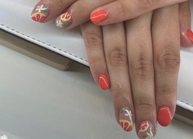 Bright floral nail art at Laura Anne Beauty, Douglas, Douglas, IM. Perfect for a vibrant summer look.