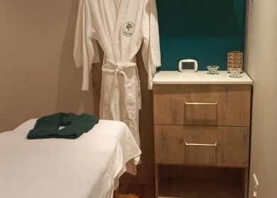 Relaxing spa treatment room at Orchard Day Spa, Durban, Kwazulu-natal, ZA with robe and massage table.