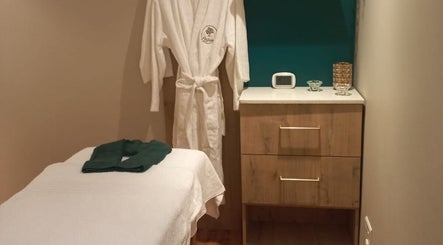 Relaxing spa treatment room at Orchard Day Spa, Durban, Kwazulu-natal, ZA with robe and massage table.