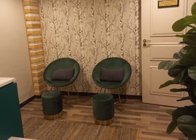 Elegant seating at Orchard Day Spa in Durban, Kwazulu-natal, ZA featuring green chairs and leafy decor.