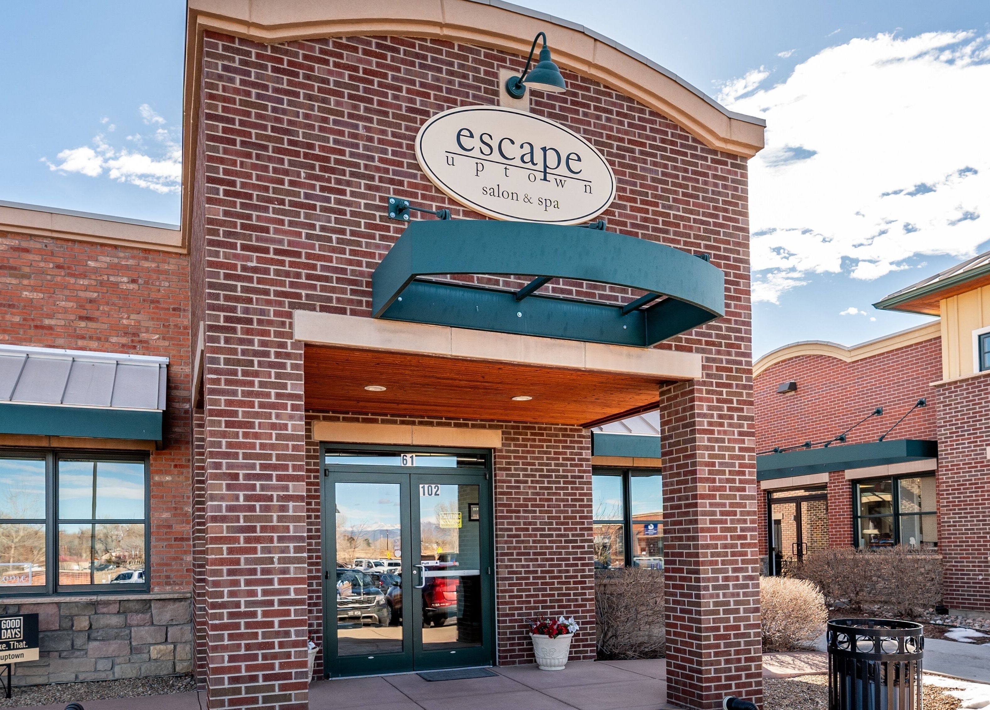 Front entrance of Escape Uptown in Erie, Colorado, US, showcasing elegant brick architecture.
