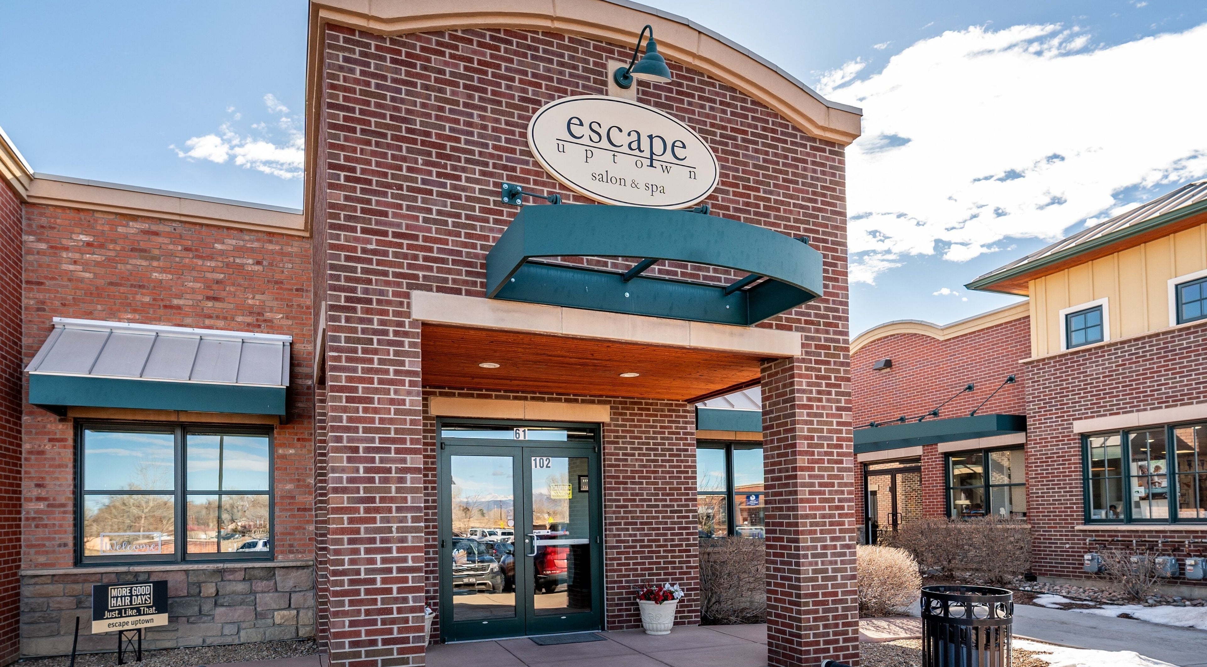 Front entrance of Escape Uptown in Erie, Colorado, US, showcasing elegant brick architecture.
