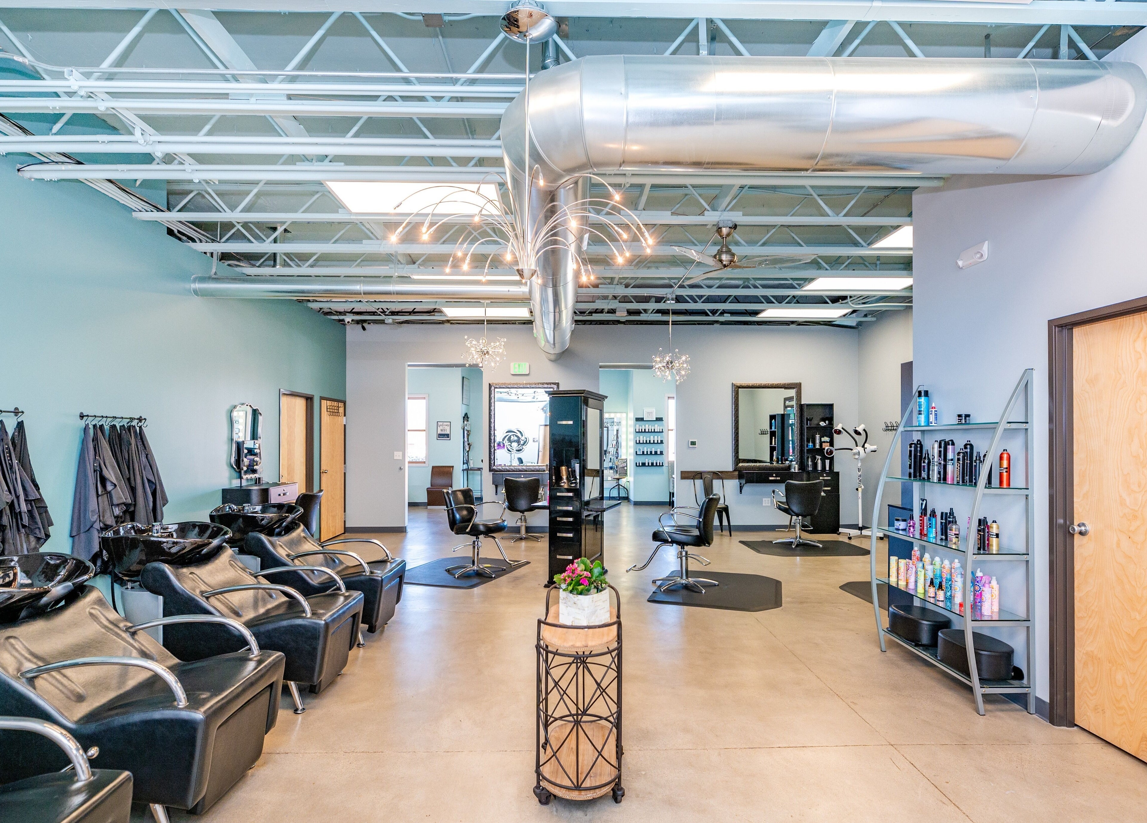 Modern salon interior at Escape Uptown, Erie, Colorado, US featuring stylish chairs and hair stations.