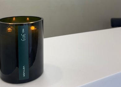 Candle illuminates the serene reception at Serènity Aesthetics, Melbourne, Victoria, AU.