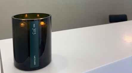 Candle illuminates the serene reception at Serènity Aesthetics, Melbourne, Victoria, AU.