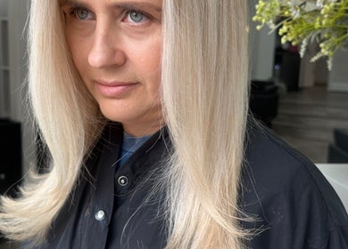 Woman with sleek blonde hair at Glam Hair By Maya in Buckhurst Hill, England, GB.