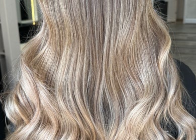 Beautiful wavy blonde hairstyle at Glam Hair By Maya, Buckhurst Hill, England, GB.