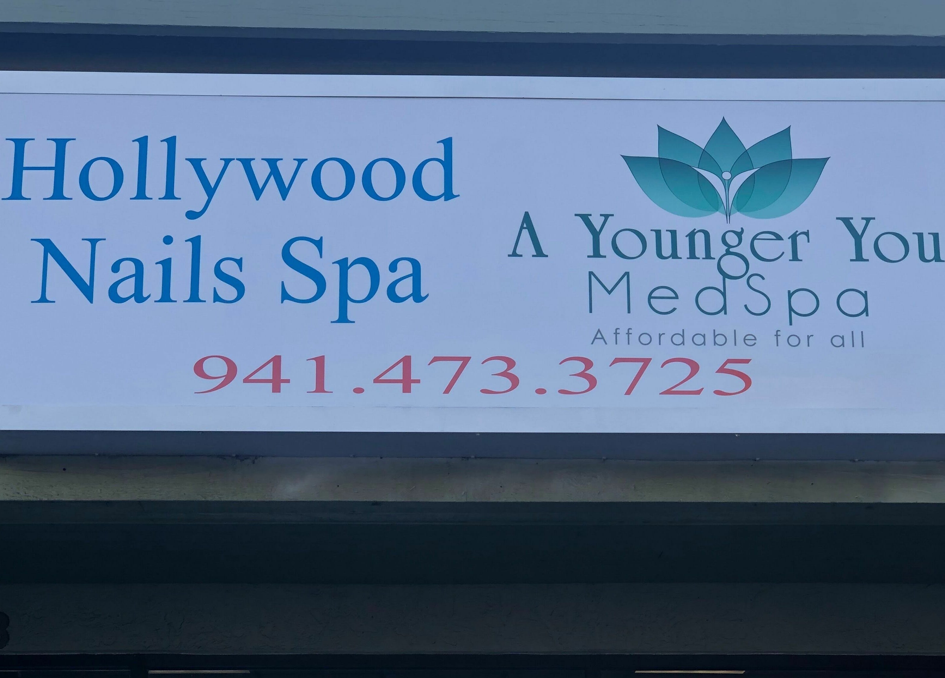 Hollywood Nails Spa sign at Englewood, Florida, US showcasing beauty and wellness offerings.