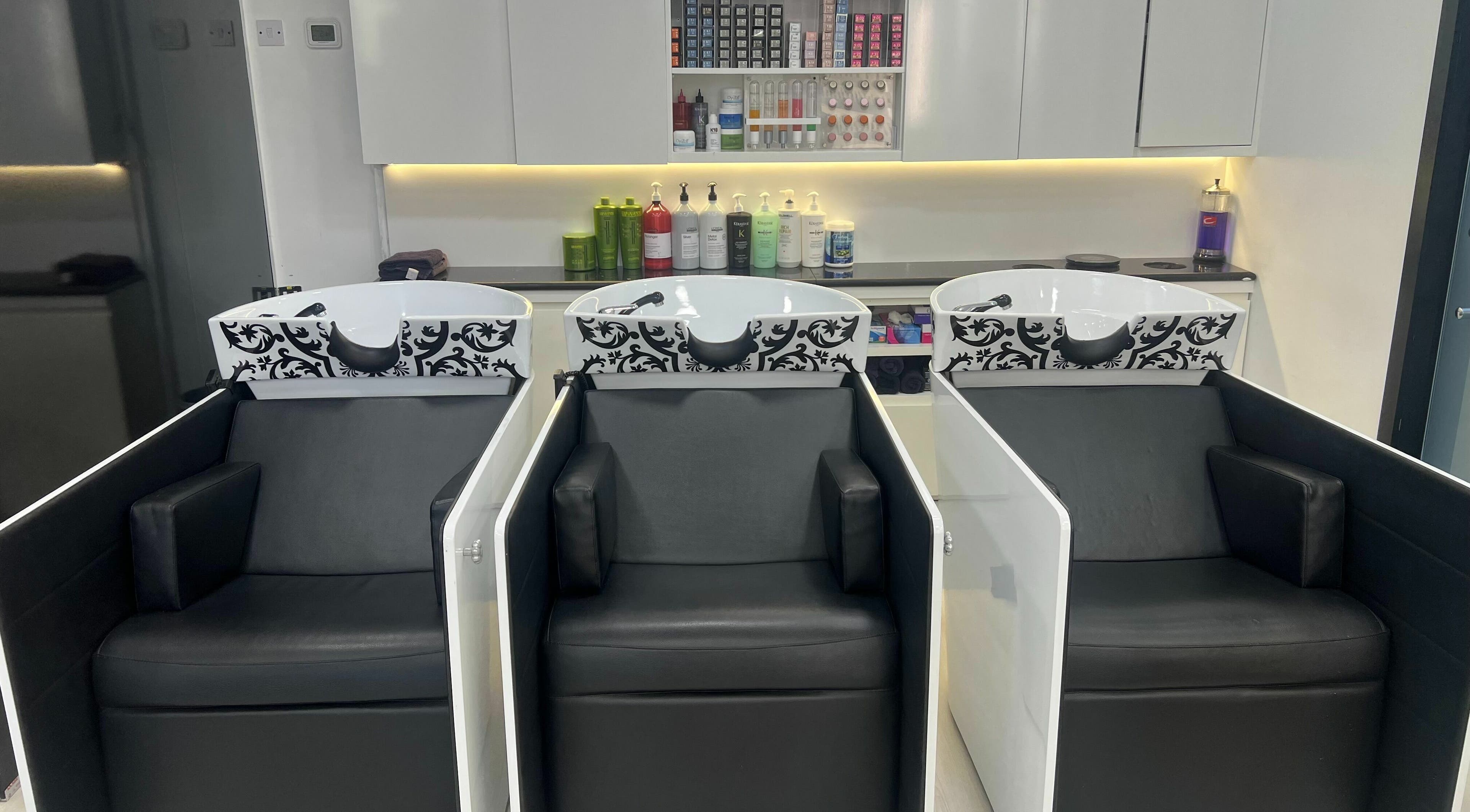 Luxury wash stations at Karim And Amin Hair and Beauty Salon | Tecom, Dubai. Stylish salon chairs and sinks.