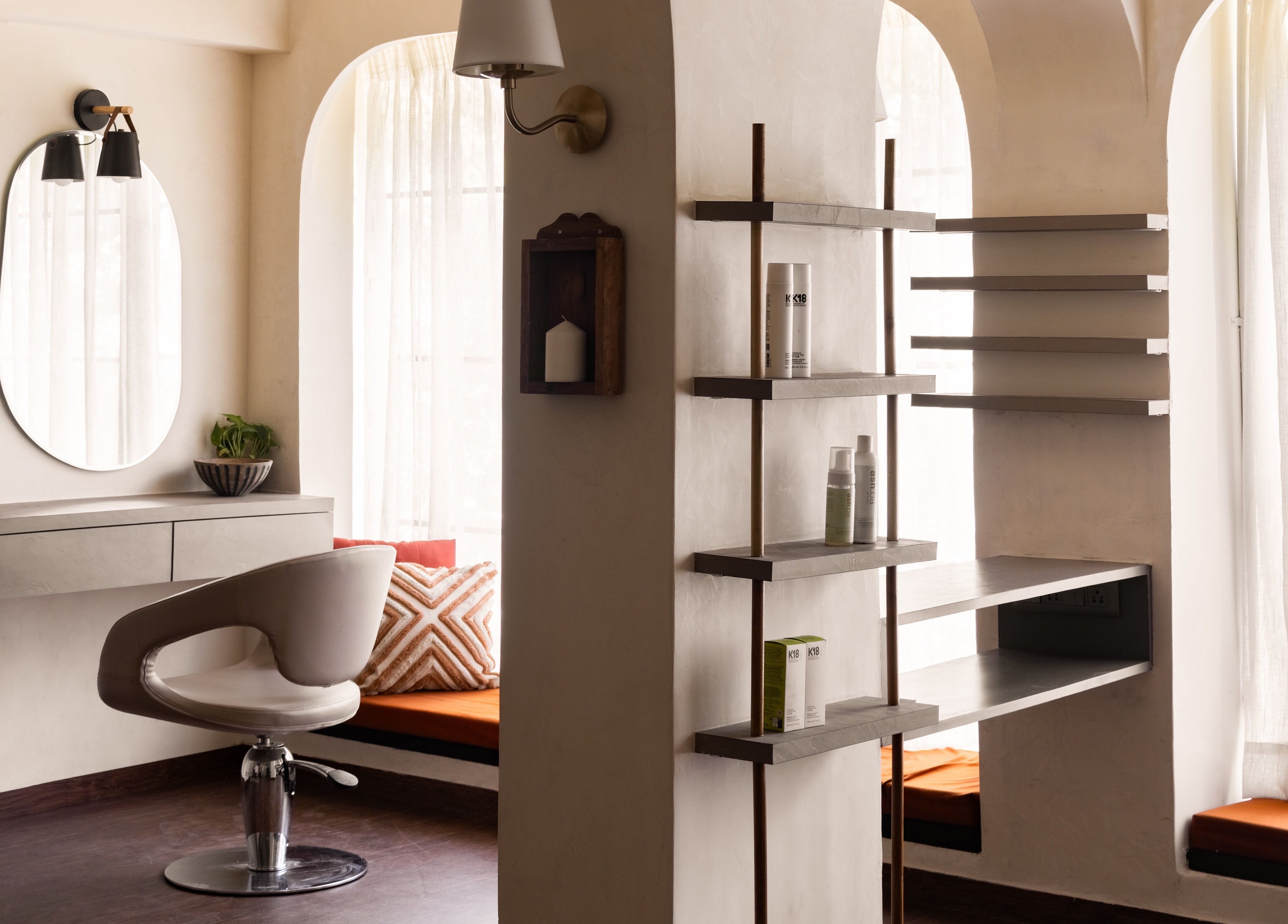 Elegant styling chair at Curls & Color Co., Thane, Maharashtra, IN with sleek shelves and modern decor.