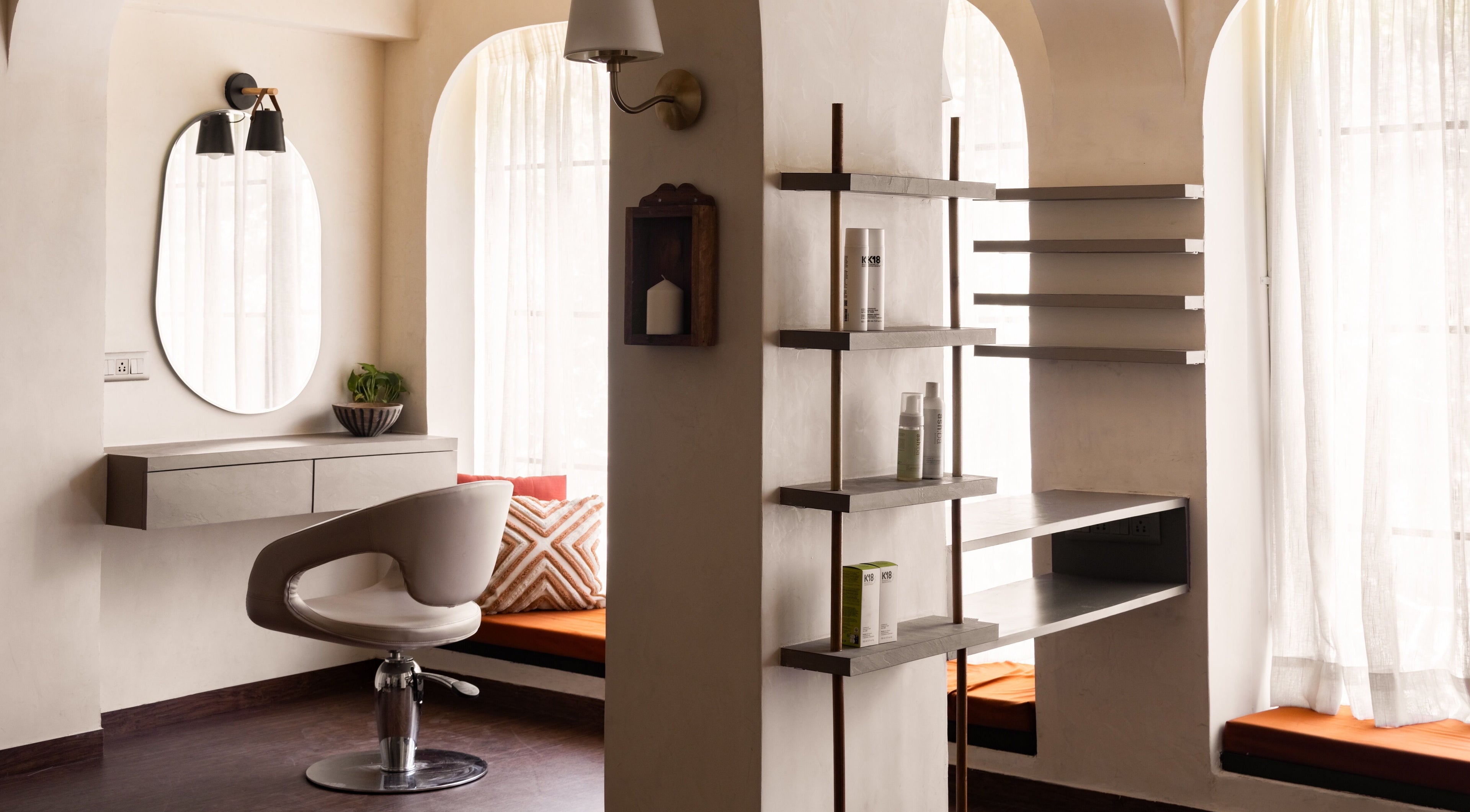 Elegant styling chair at Curls & Color Co., Thane, Maharashtra, IN with sleek shelves and modern decor.