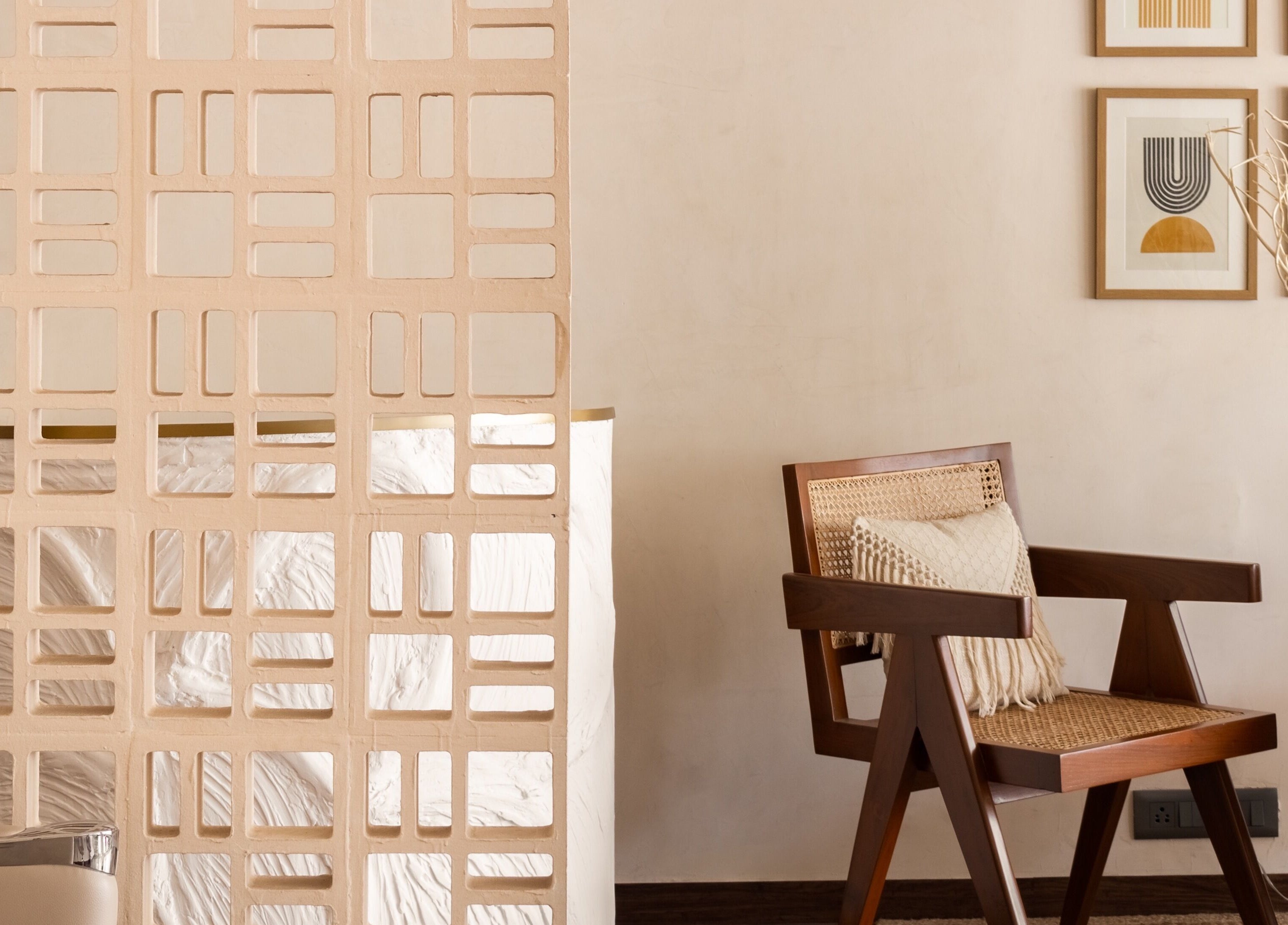 Elegant seating area at Curls & Color Co., Thane, Maharashtra, IN with modern decor and artwork.