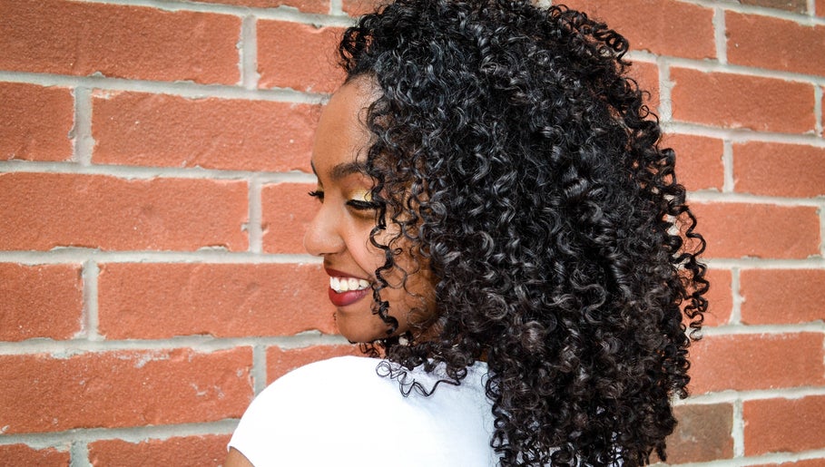 Bright smile with stunning curls at Natural Curly Haven, Toronto, Ontario, CA. Embrace curly beauty.