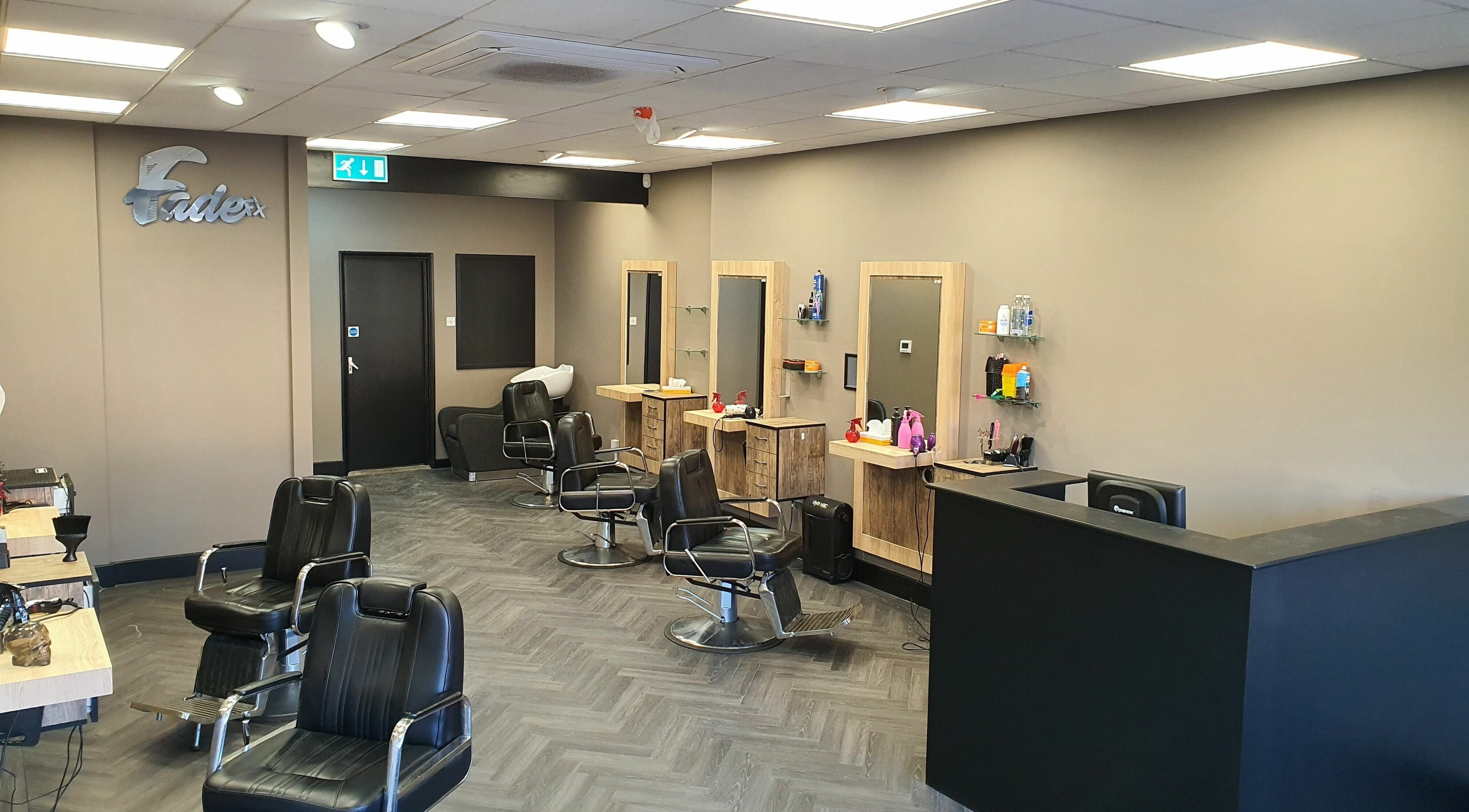 Modern interior of Fade FX Barber's in Kempston, England, GB with sleek chairs and mirrors.