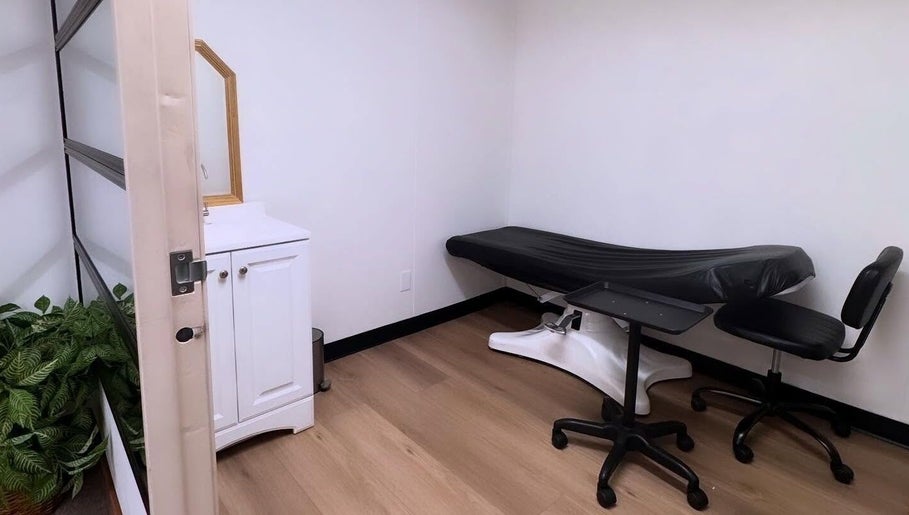 Serene treatment room at MMBW Industry, Ventura, California, US with massage bed and minimalist decor.