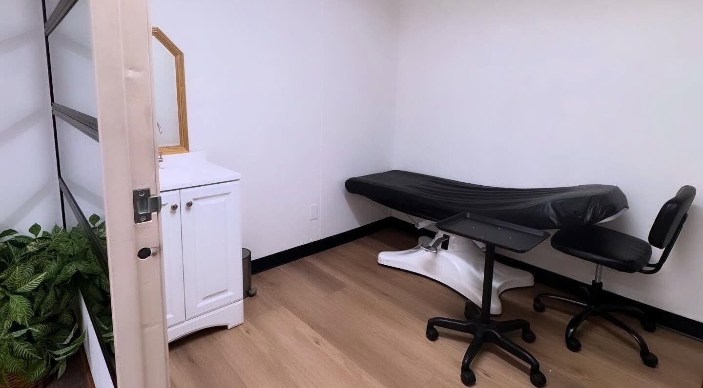 Serene treatment room at MMBW Industry, Ventura, California, US with massage bed and minimalist decor.