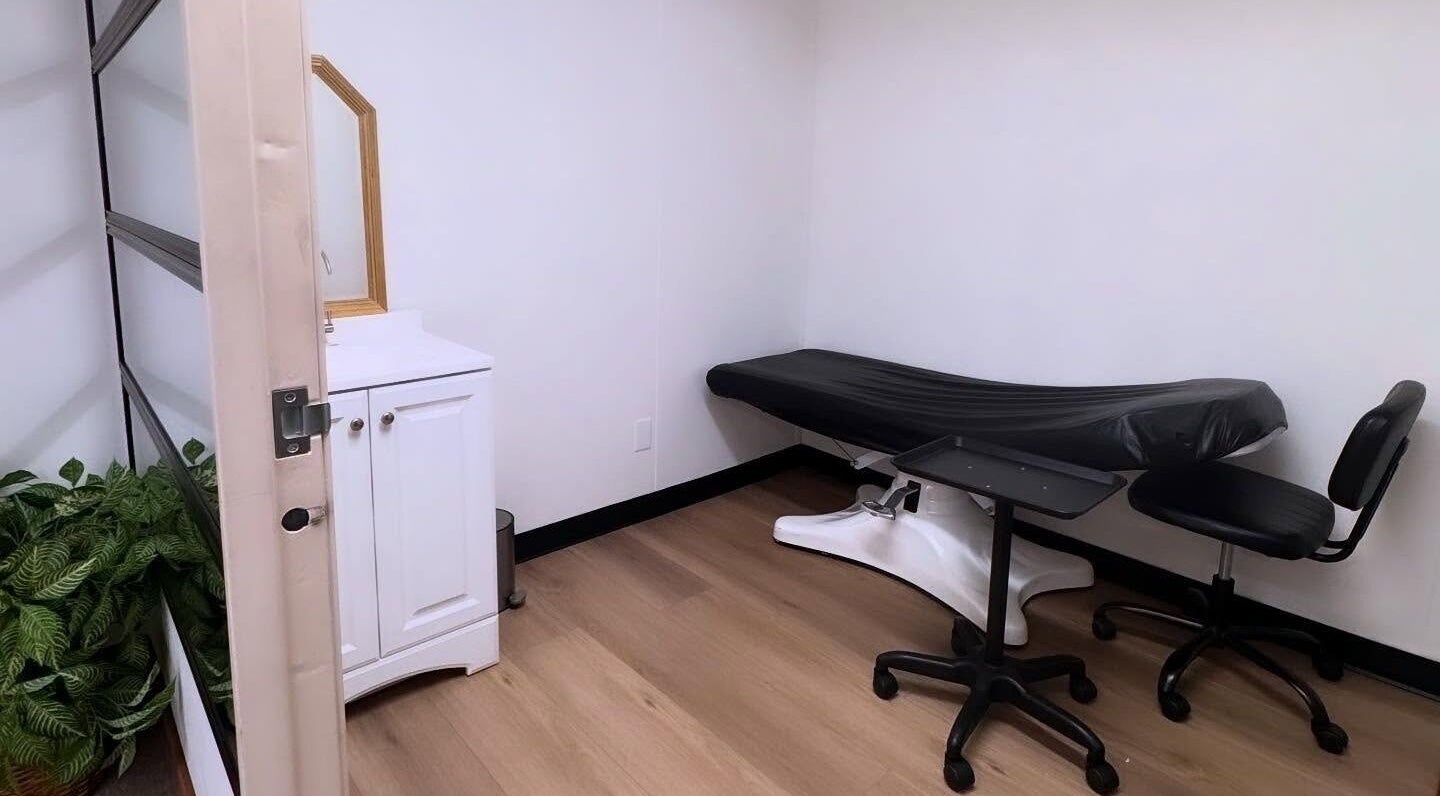 Serene treatment room at MMBW Industry, Ventura, California, US with massage bed and minimalist decor.