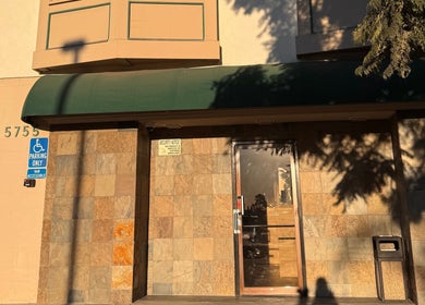 Entrance of MMBW Industry in Ventura, California, US with accessible parking sign in sunlight.