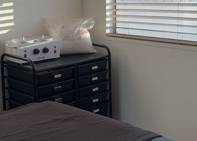 Relaxing treatment room at MMBW Industry in Ventura, California, US, featuring a creamy masked machine and cozy bed.
