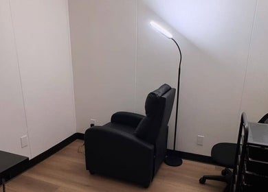 Relaxing corner at MMBW Industry in Ventura, California, US with a plush chair and modern lamp.
