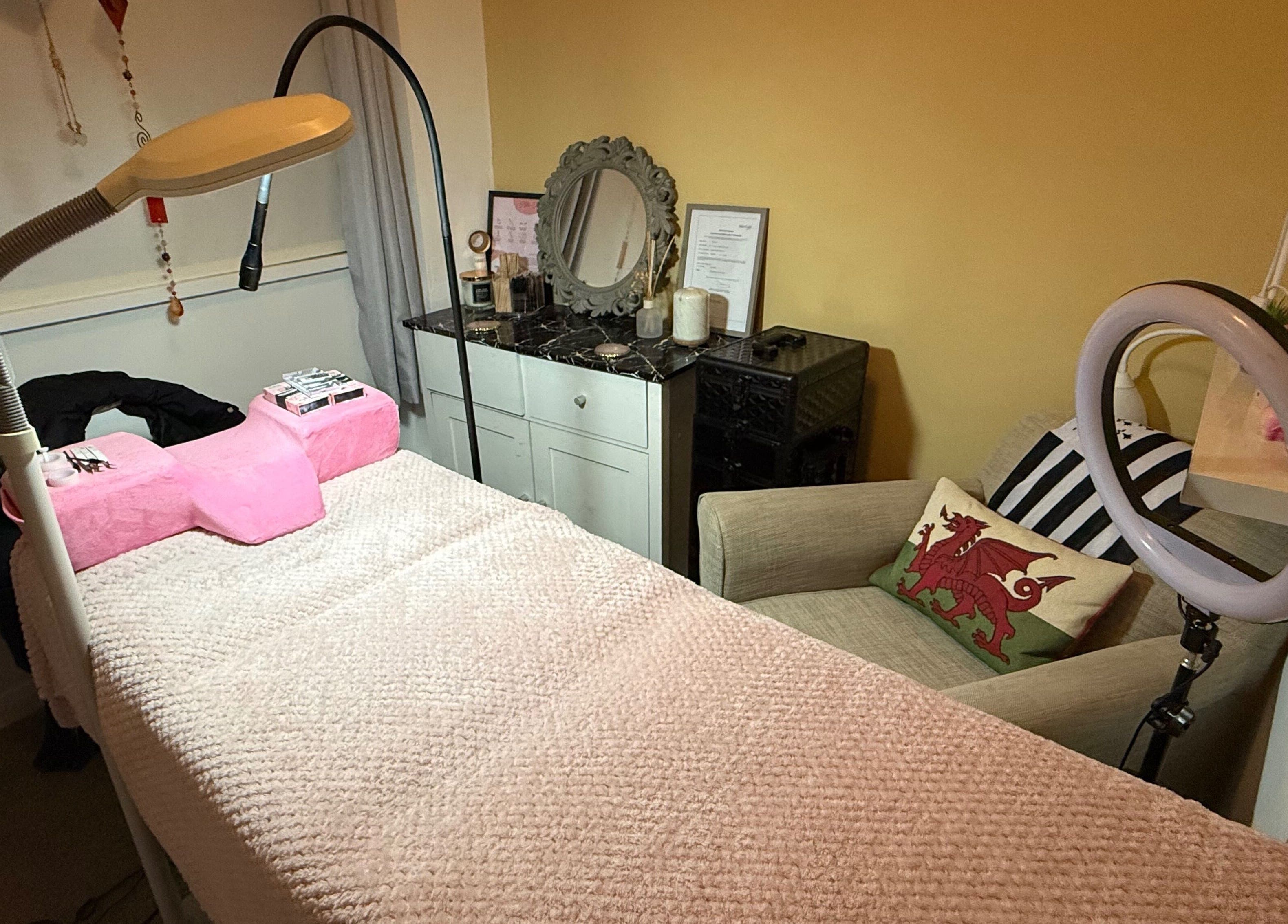 Cozy treatment room at Leeswood, Leeswood, Wales, GB, featuring a plush bed and elegant decor.