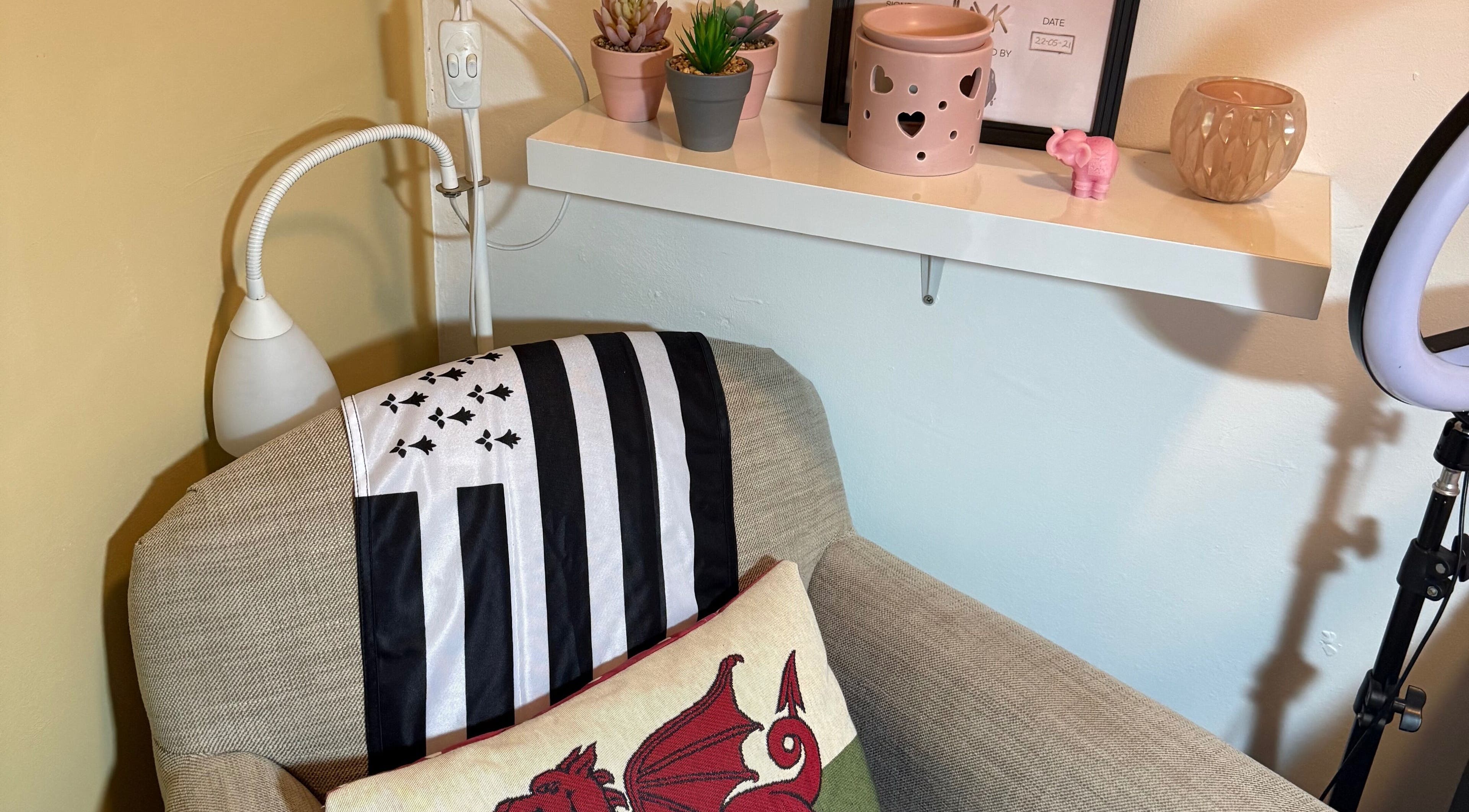 Leeswood venue's cozy corner with plush armchair in Leeswood, Wales, GB. Features decorative pillows and shelf.