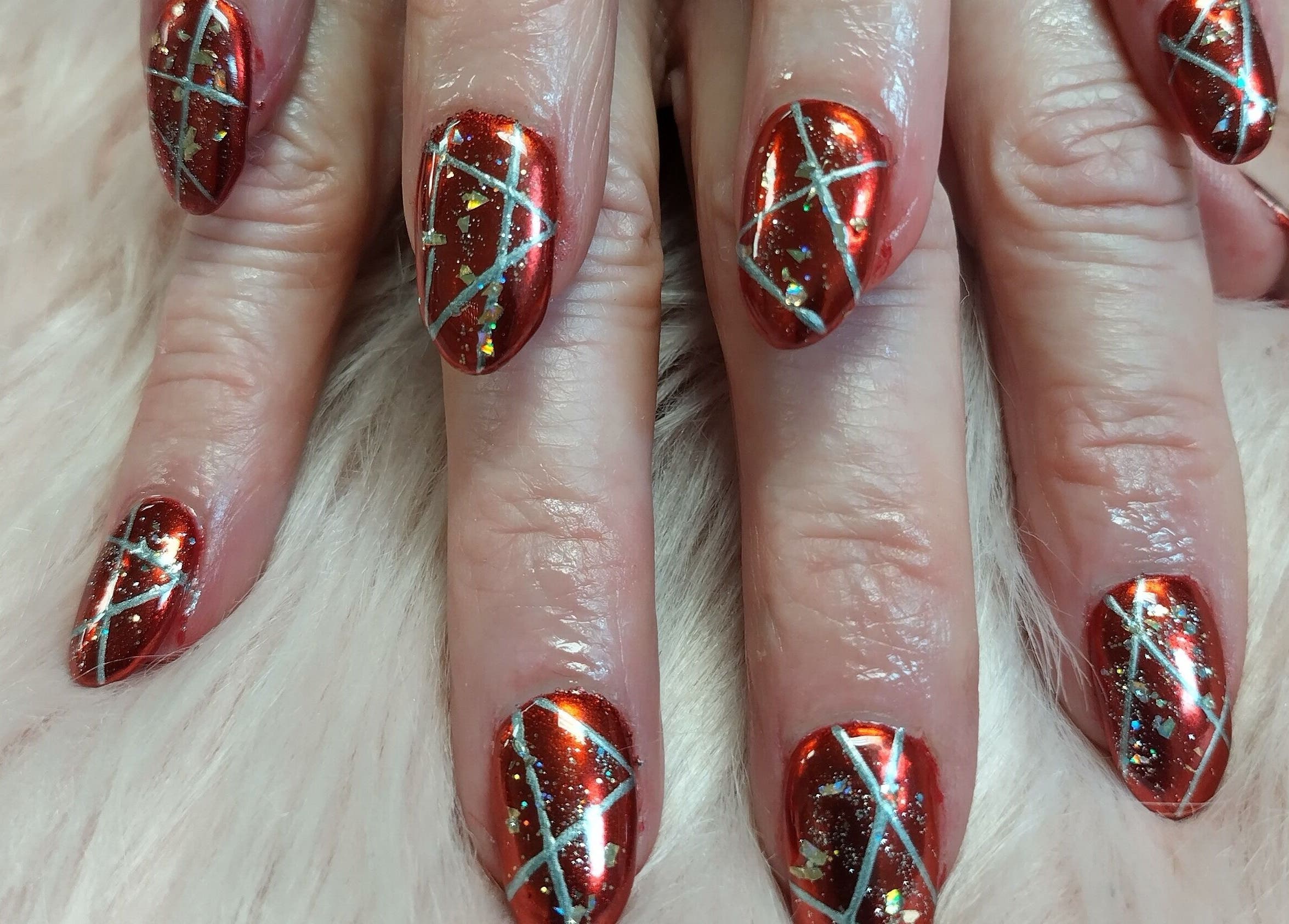 Intricate red nail art at Chabaa Private Nail Salon in Branson, Missouri, US.