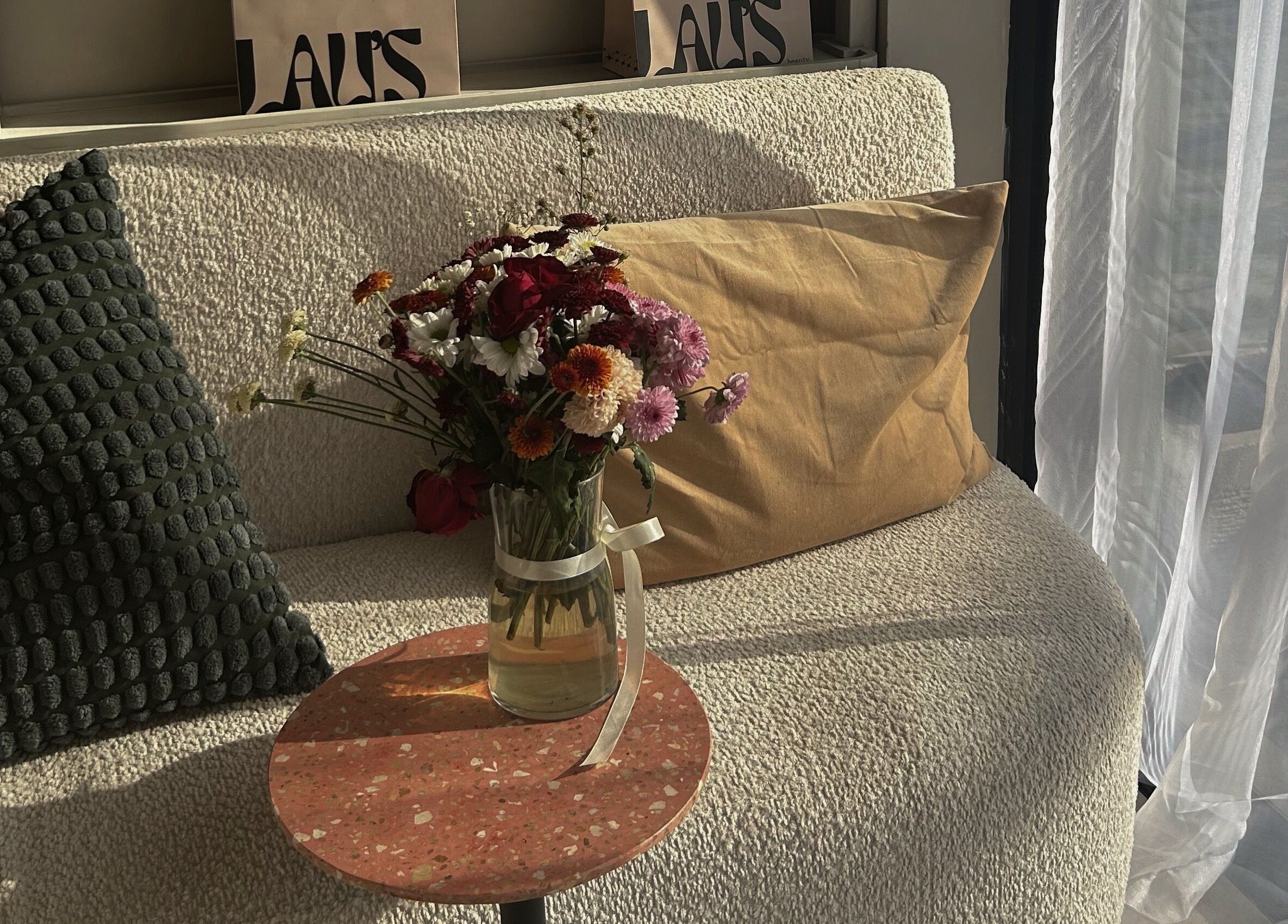 Sunlit sofa with floral arrangement at LAU’S BEAUTY, Bali, Bali, ID, enhancing relaxation space.