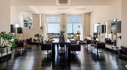 Bright, chic interior of Marcella Hair in Margate, England, GB with ocean view.