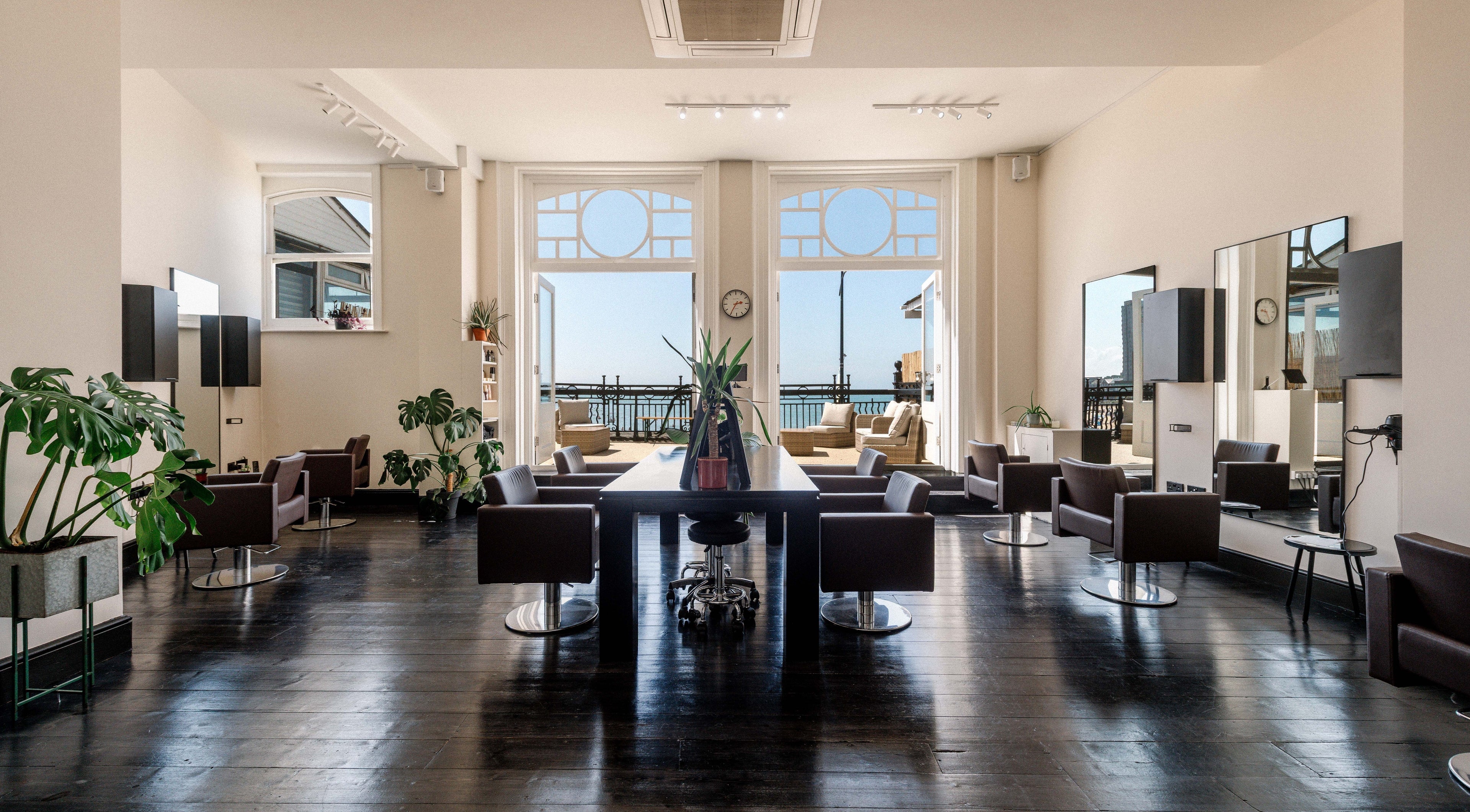Bright, chic interior of Marcella Hair in Margate, England, GB with ocean view.