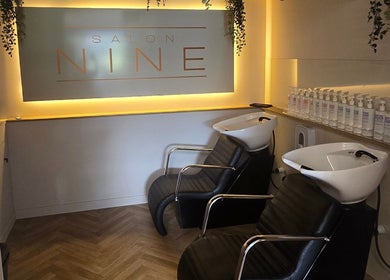 Luxurious shampoo area at Salon Nine, Glenrothes, Scotland, GB with sleek chairs and product display.