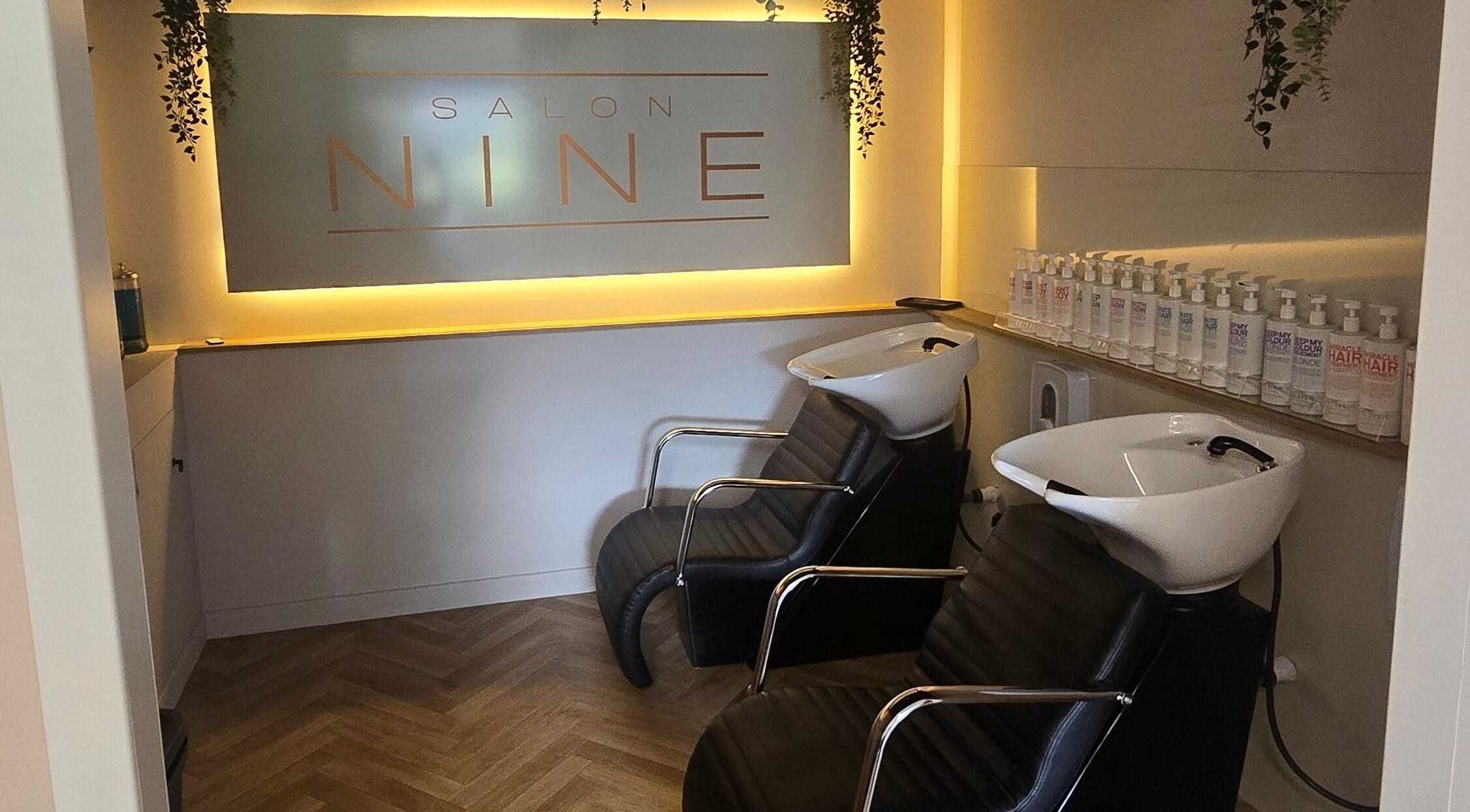 Luxurious shampoo area at Salon Nine, Glenrothes, Scotland, GB with sleek chairs and product display.
