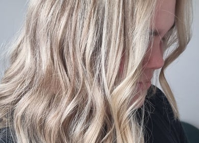 Elegant blonde waves styled at Salon Nine, Glenrothes, Scotland, GB showcasing vibrant hair texture.