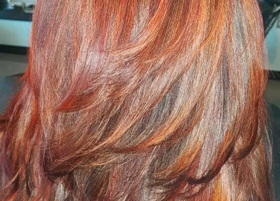 Vibrant red and copper hair at Bentley's Salon and Barbershop, Schuylerville, New York, US.