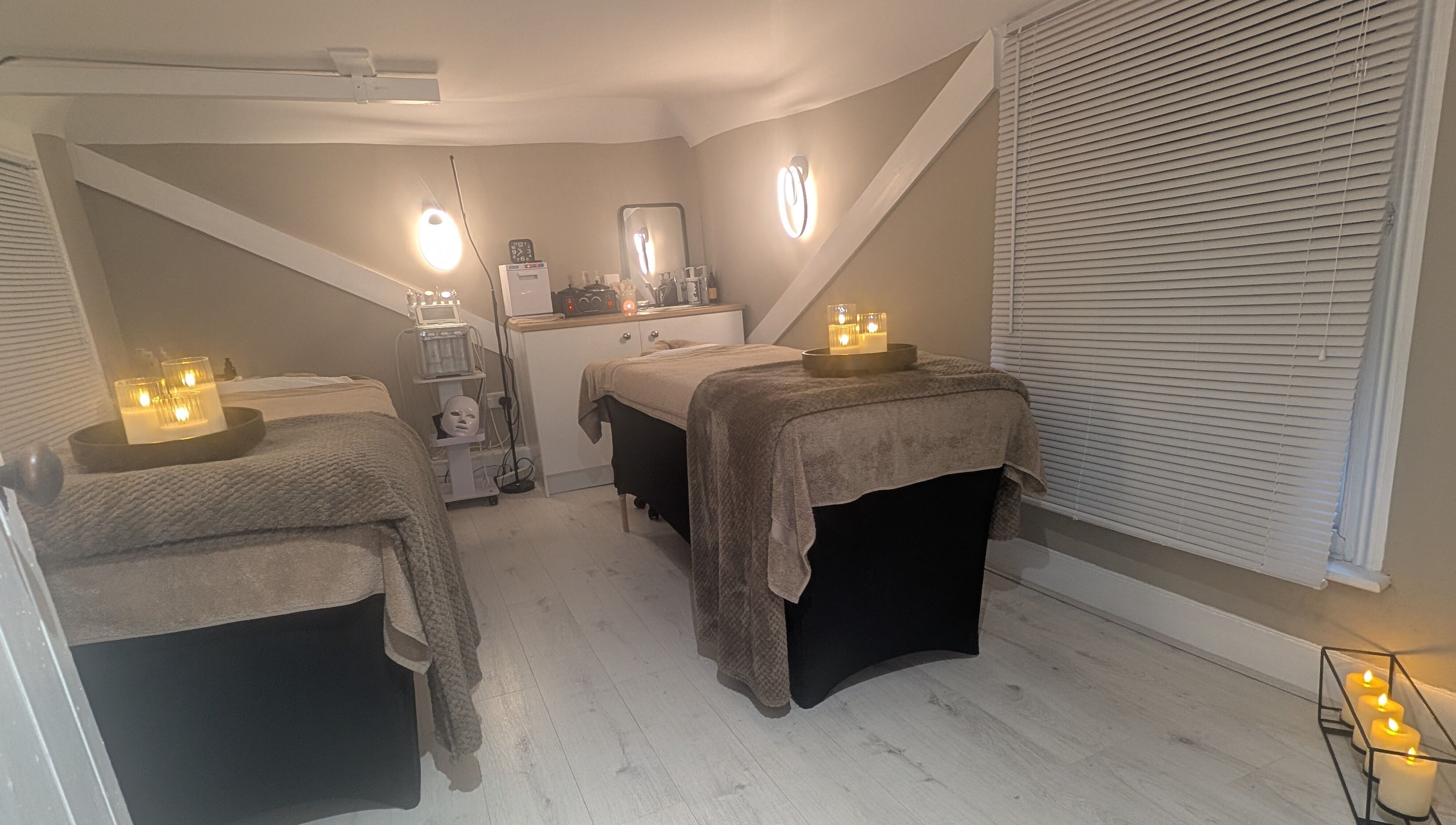 Tranquil treatment room at Beauty Corner, Ashford, England, GB. Cozy beds with candlelight for ultimate relaxation.