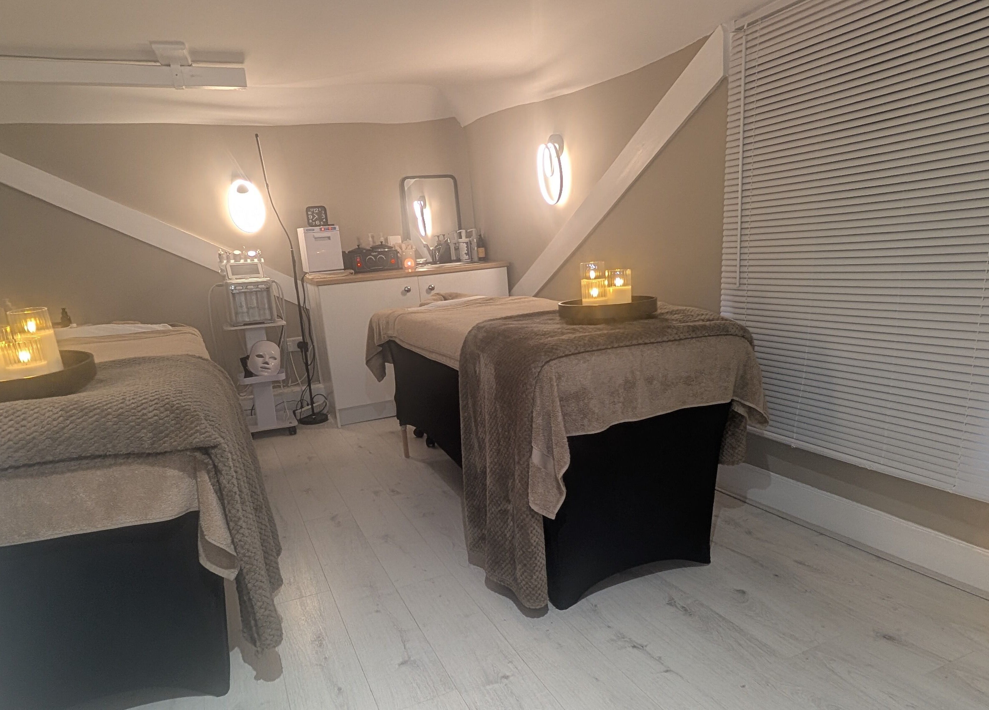 Tranquil treatment room at Beauty Corner, Ashford, England, GB. Cozy beds with candlelight for ultimate relaxation.
