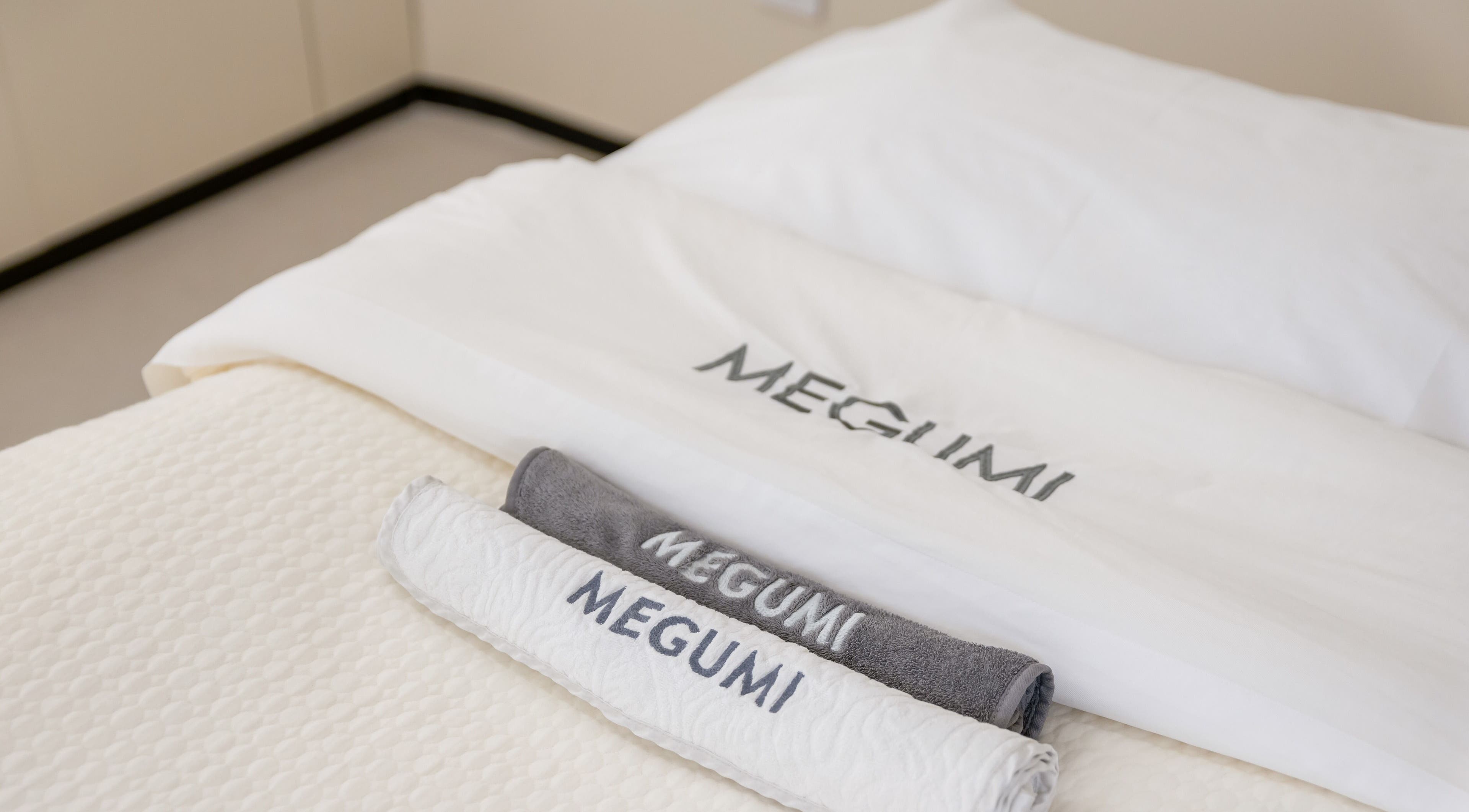 Luxury towels branded MEGUMI GLOBAL in a serene spa setting, Sydney, New South Wales, AU.
