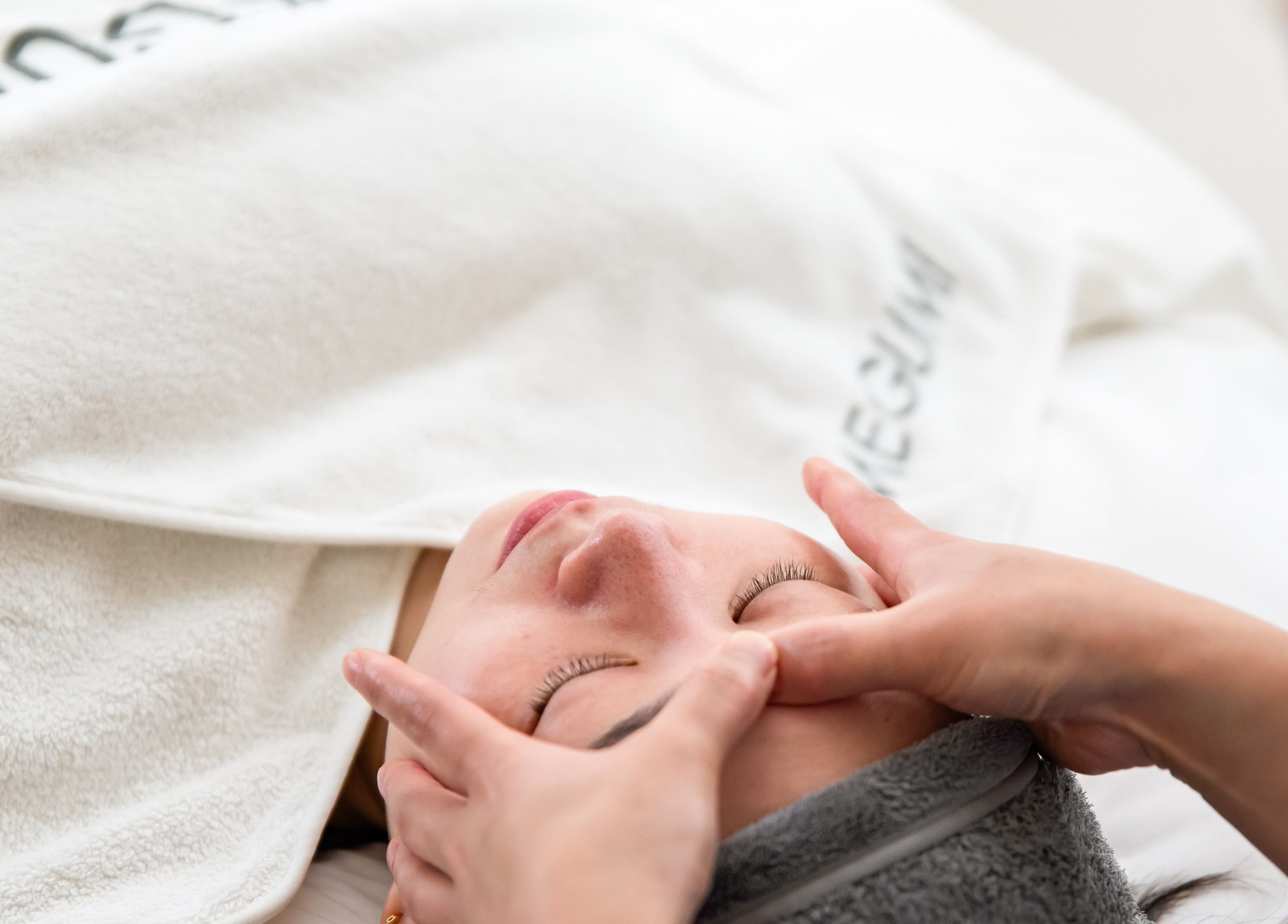 Facial massage at MEGUMI GLOBAL, Sydney, New South Wales. Relaxation and rejuvenation in a serene setting.