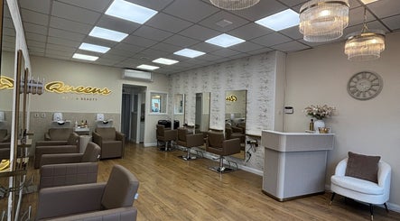 Elegant interior of Queens Hair & Beauty, Bristol, England, GB, featuring stylish chairs and modern decor.