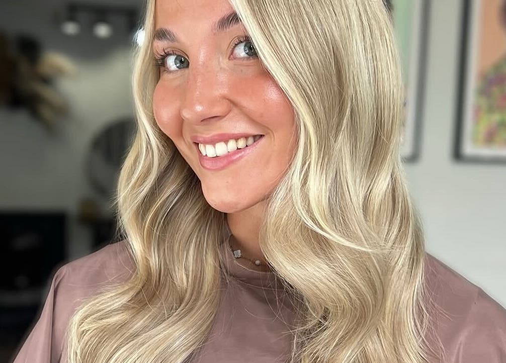 Smiling woman with blonde waves at Pembroke - By Ami, Pembroke, Wales, GB.