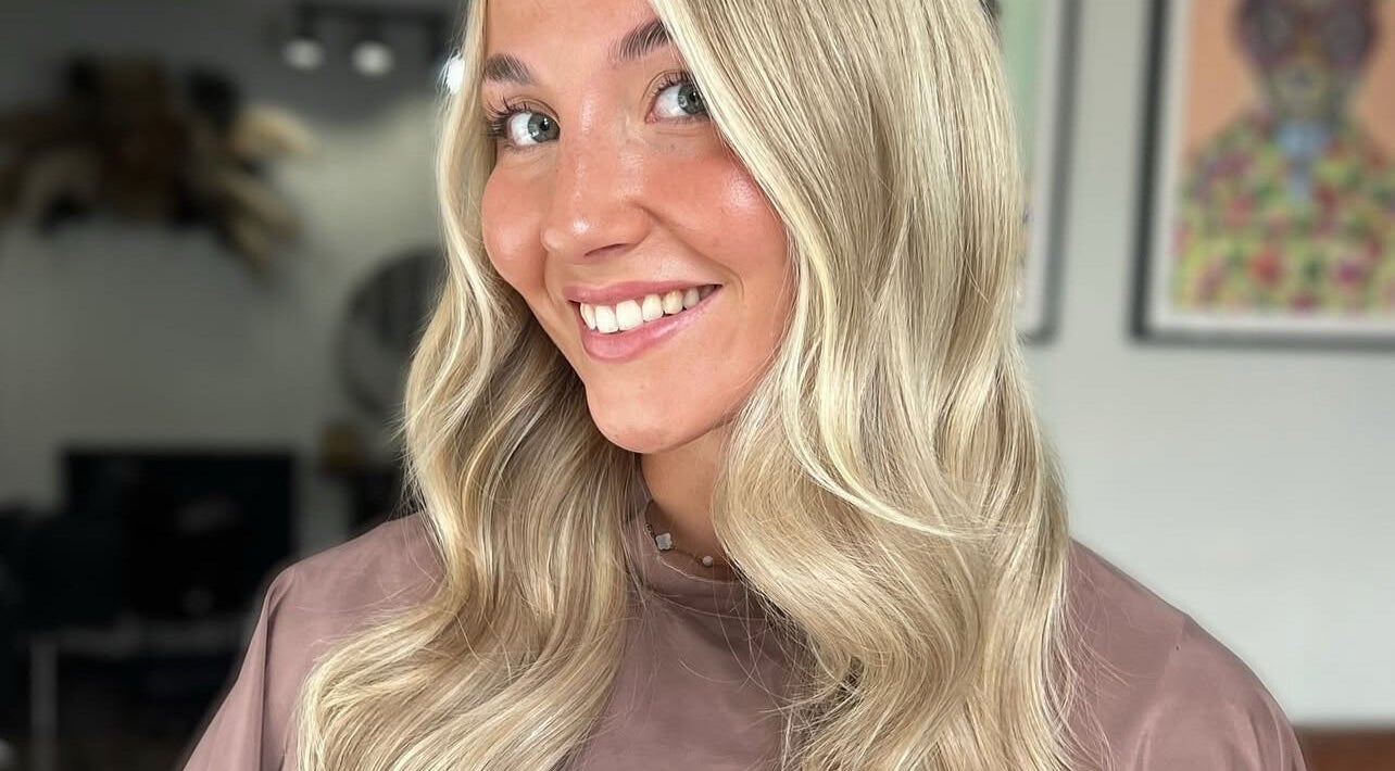 Smiling woman with blonde waves at Pembroke - By Ami, Pembroke, Wales, GB.