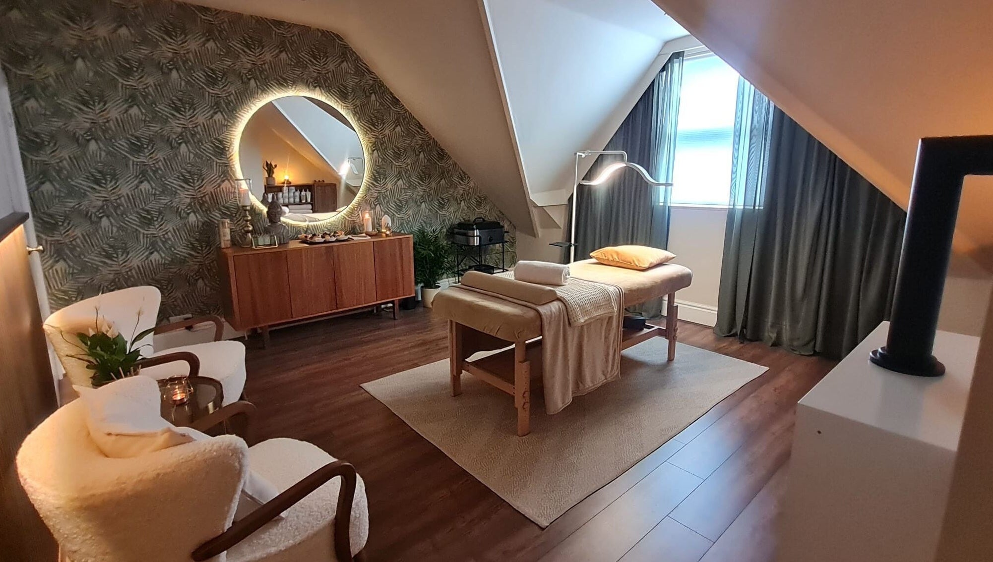 Cozy spa room at Cute Guru, West Bromwich, England, GB with massage table and soft lighting.