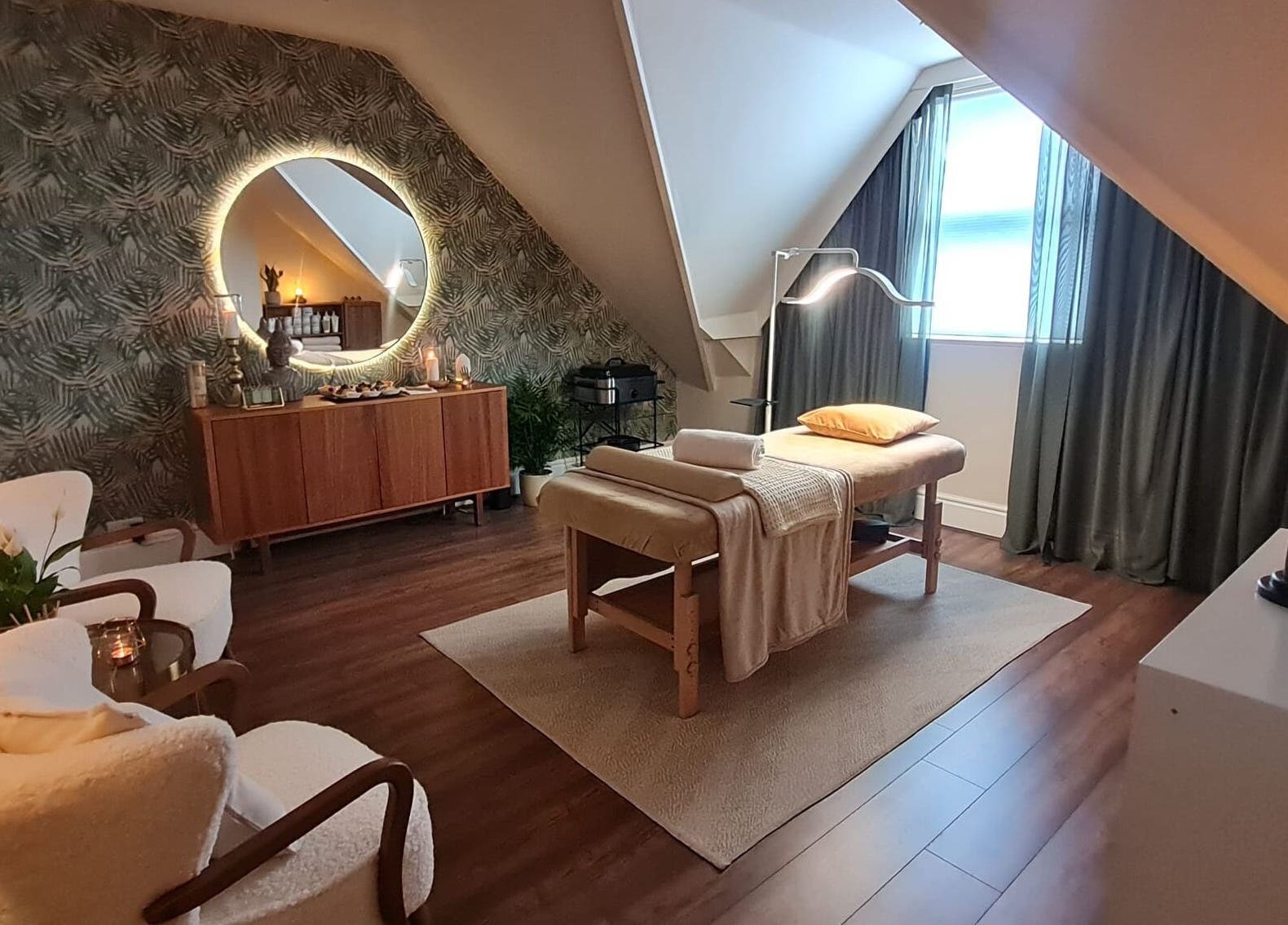 Cozy spa room at Cute Guru, West Bromwich, England, GB with massage table and soft lighting.