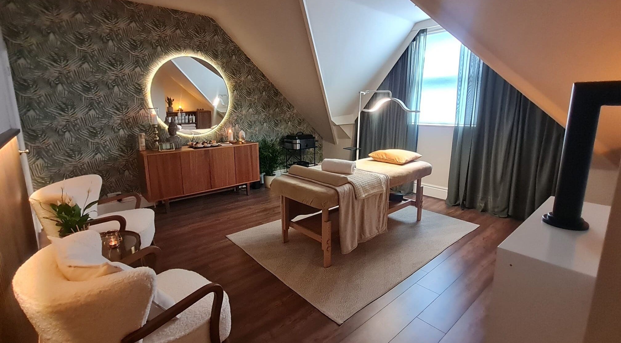 Cozy spa room at Cute Guru, West Bromwich, England, GB with massage table and soft lighting.