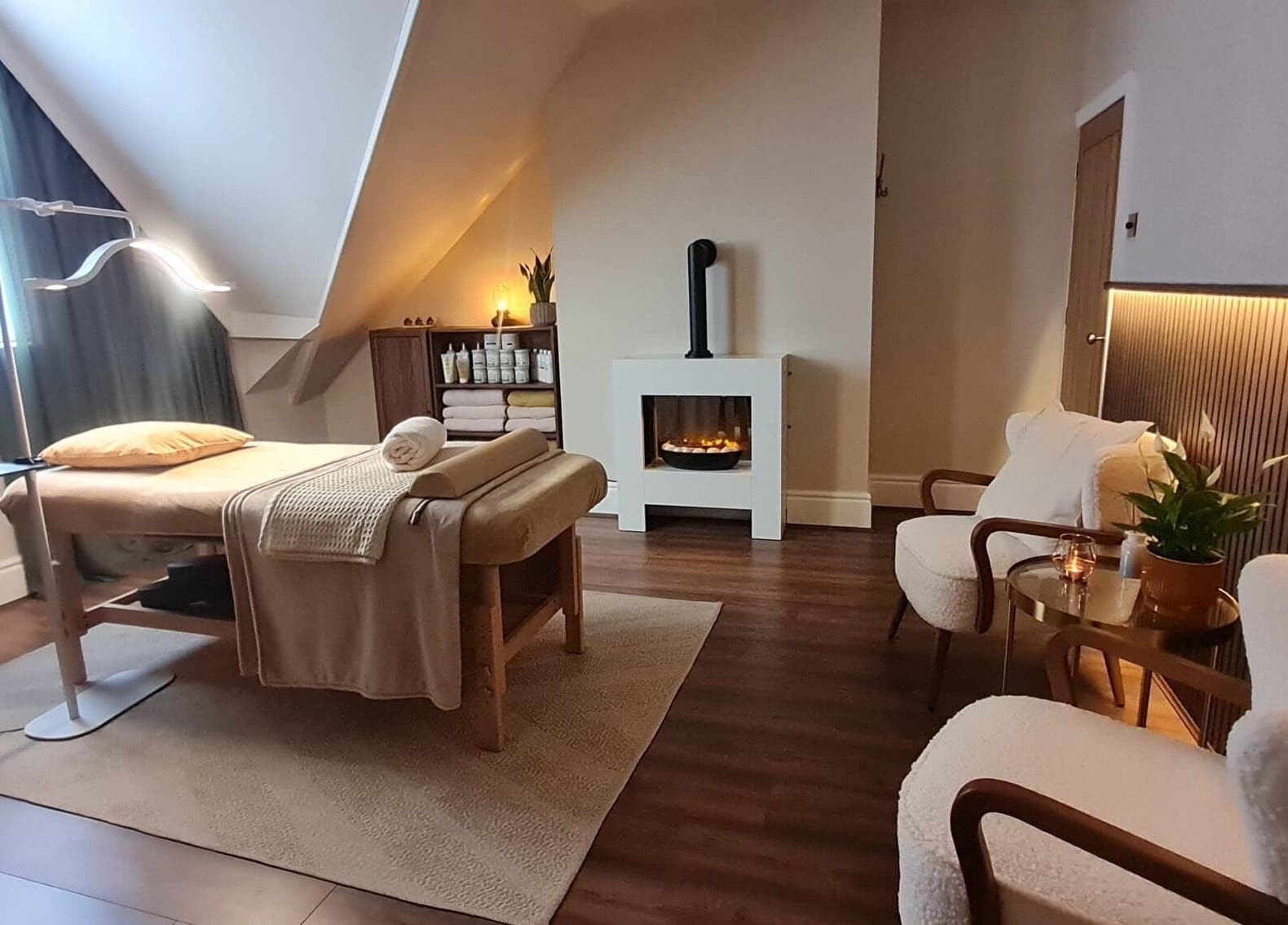 Cozy massage room at Cute Guru, West Bromwich, England, GB with ambient lighting and comfy seating.