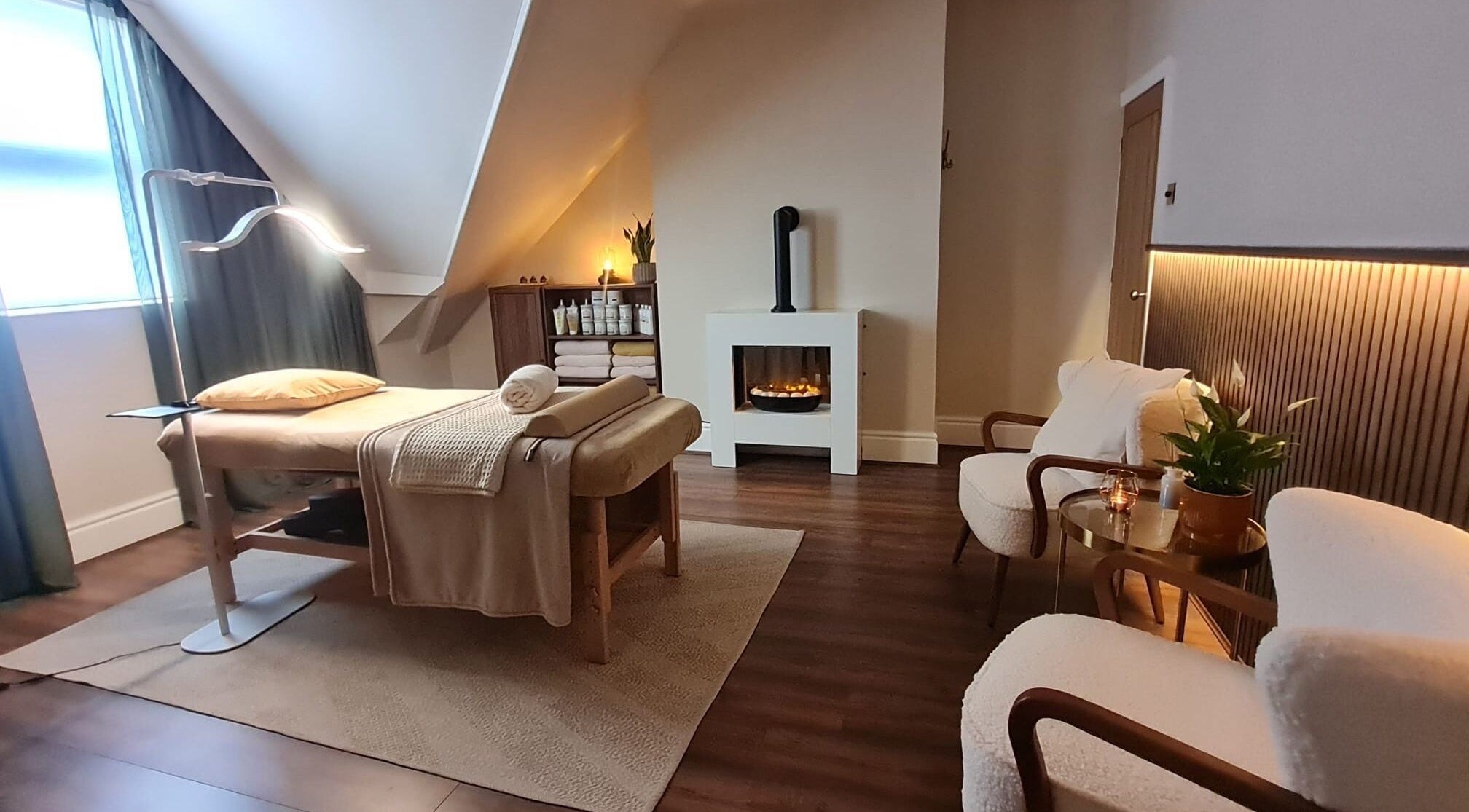 Cozy massage room at Cute Guru, West Bromwich, England, GB with ambient lighting and comfy seating.