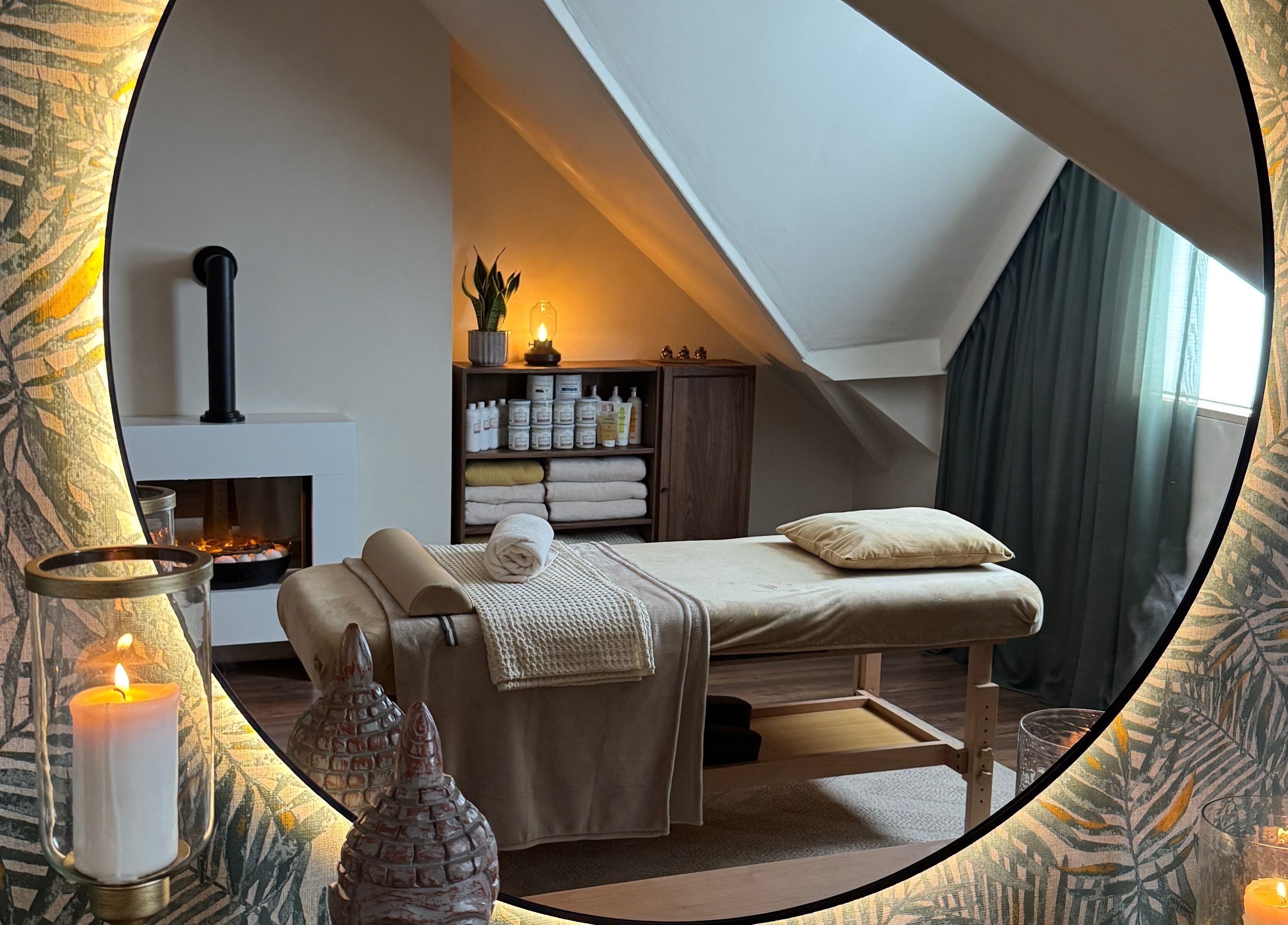 Relaxing massage room at Cute Guru, West Bromwich, England, GB with candles and soothing decor.