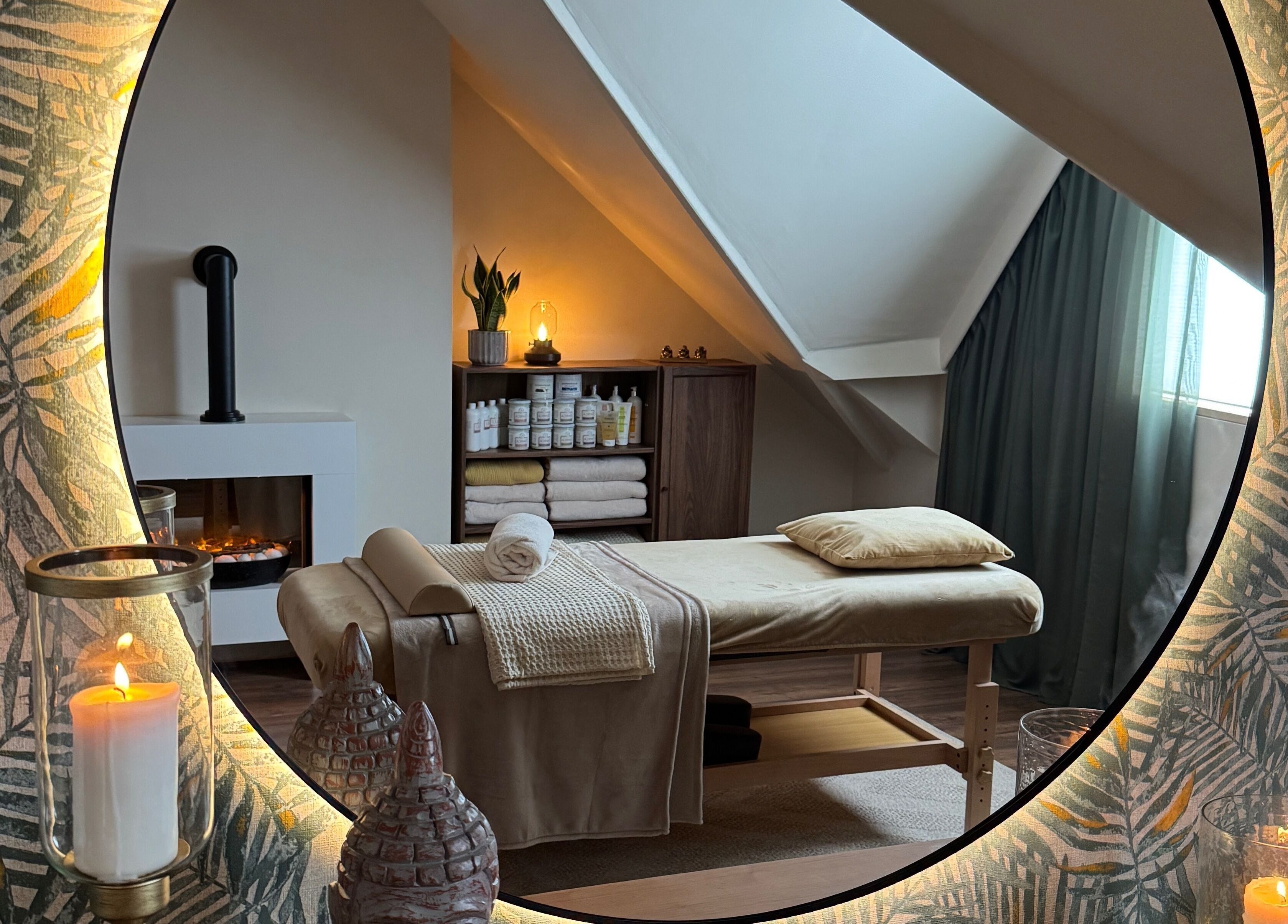 Relaxing massage room at Cute Guru, West Bromwich, England, GB with candles and soothing decor.